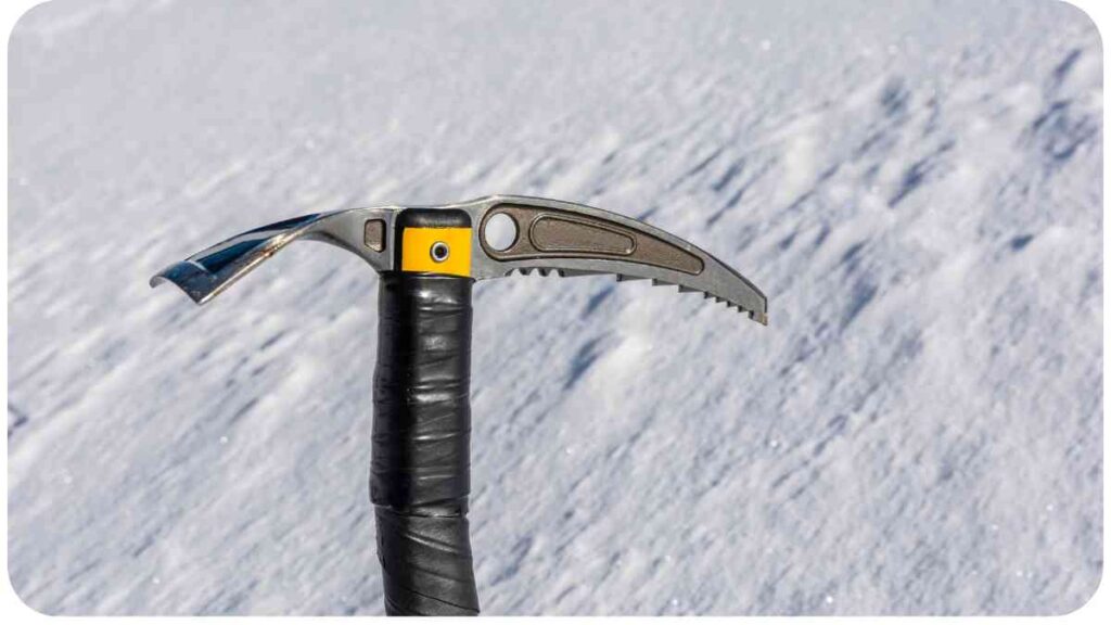 a close up of a knife on top of a snow covered hill.