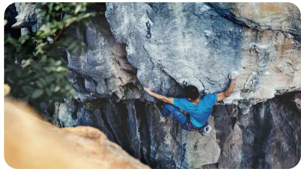 a rock climber is hanging off the side of a cliff