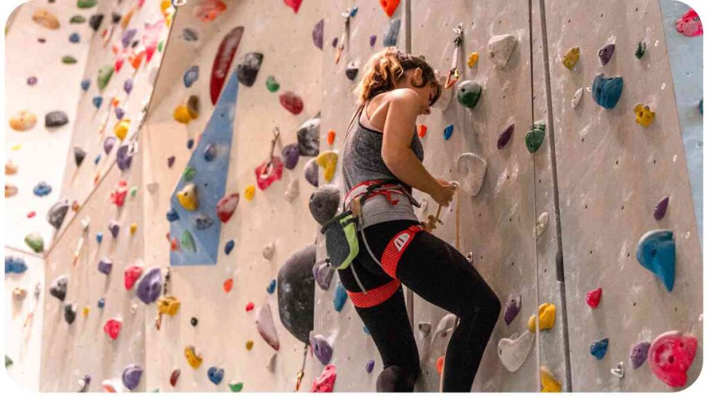 a person is climbing on an indoor climbing wall