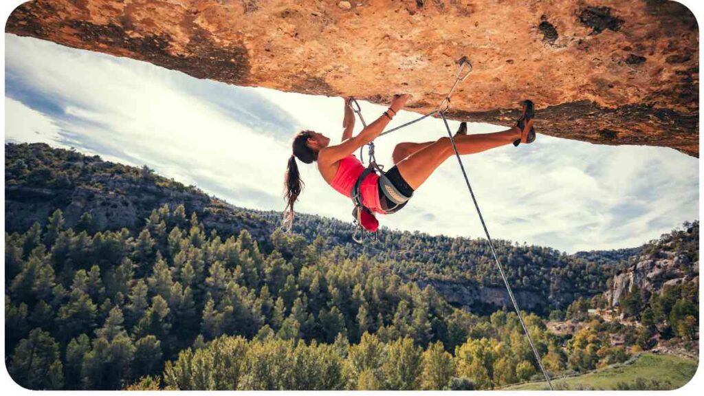 a rock climber is hanging off the side of a cliff